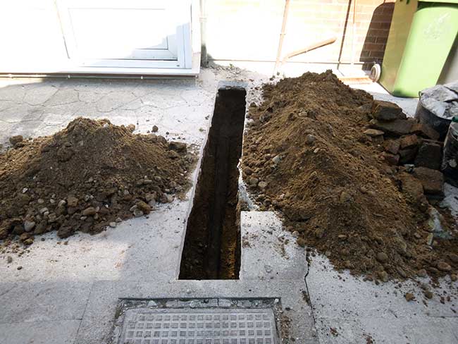 Slit trench dug for new sewer installation